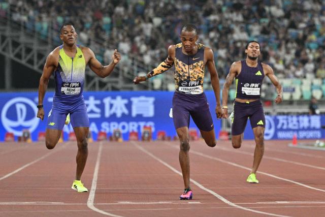 Botswana's Busang Collen Kebinatshipi (C) crosses the finish line to win in the men's 400m final event during the Xiamen Diamond League athletics meeting at Egret Stadium in Xiamen, in China’s eastern Fujian province on May 23, 2026. (Photo by Hector RETAMAL / AFP)