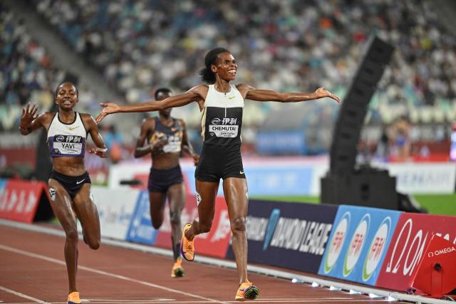 Uganda's Peruth Chemutai (R) reacts as she crosses the finish line to win in the women's 3000m steeplechase final event during the Xiamen Diamond League athletics meeting at Egret Stadium in Xiamen, in China’s eastern Fujian province on May 23, 2026. (Photo by Hector RETAMAL / AFP)