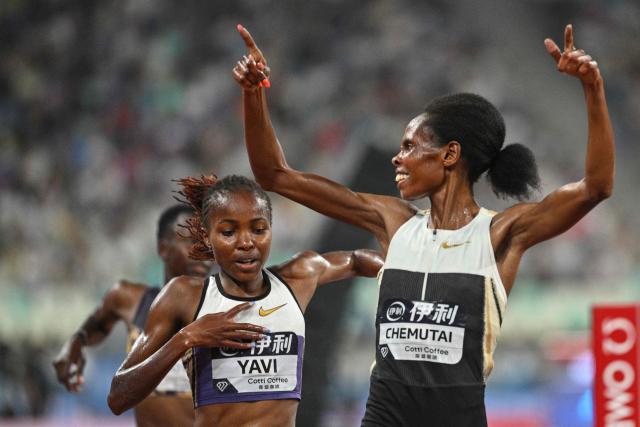 Uganda's Peruth Chemutai (R) celebrates after crossing the finish line to win ahead of Bahrain's Winfred Yavi (L) in the women's 3000m steeplechase final event during the Xiamen Diamond League athletics meeting at Egret Stadium in Xiamen, in China’s eastern Fujian province on May 23, 2026. (Photo by Hector RETAMAL / AFP)