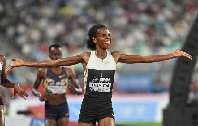 Uganda's Peruth Chemutai reacts as she crosses the finish line to win in the women's 3000m steeplechase final event during the Xiamen Diamond League athletics meeting at Egret Stadium in Xiamen, in China’s eastern Fujian province on May 23, 2026. (Photo by Hector RETAMAL / AFP)