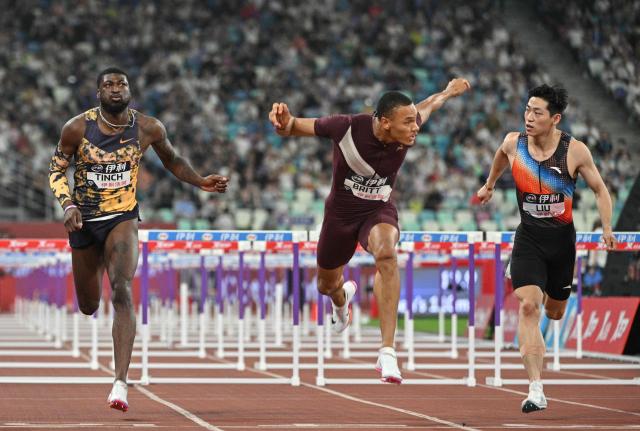 USA's Jamal Britt (C) crosses the finish line to win in the men's 110m hurdles final event during the Xiamen Diamond League athletics meeting at Egret Stadium in Xiamen, in China’s eastern Fujian province on May 23, 2026. (Photo by Hector RETAMAL / AFP)