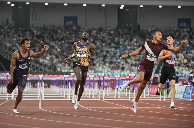 USA's Jamal Britt (2nd) reacts after winning in the men's 110m hurdles final event during the Xiamen Diamond League athletics meeting at Egret Stadium in Xiamen, in China’s eastern Fujian province on May 23, 2026. (Photo by Hector RETAMAL / AFP)