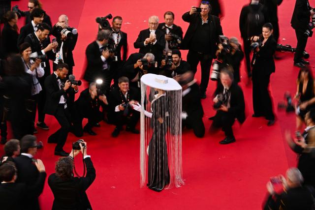 (FILES) Photographers gather on the red carpet to photograph El Salvador model Rakele Menjivar arriving for the screening of the film "Amarga Navidad" (Bitter Christmas) at the 79th edition of the Cannes Film Festival in Cannes, southern France on May 19, 2026.  (Photo by Antonin THUILLIER / AFP)