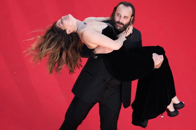 (FILES) French actor Vincent Macaigne carries French actress and model Laetitia Casta on the red carpet as they arrive for the screening of the film "Karma" at the 79th edition of the Cannes Film Festival in Cannes, southern France on May 15, 2026.  (Photo by Valery HACHE / AFP)