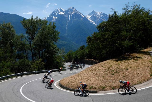 Riders take a curve during the 14th stage of the Giro d'Italia 2026 - Tour of Italy cycling race between Aosta and Pila (Gressan), Italy, on May 23, 2026. (Photo by Luca Bettini / AFP)