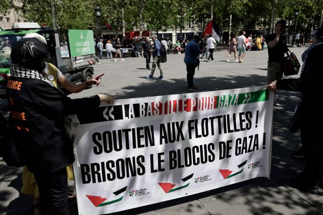 Demonstrators hold a banner reading "Support the flotillas! Lets break the blockade of Gaza !" as French activists of the Global Sumud Gaza-bound flotilla and protesters gather take part in a demonstration in solidarity with Palestinians, to condemn the interception of the Global Sumud Flotilla by the Israeli army, at the Place de la Republique in Paris on May 23, 2026. The 37 French nationals were among some 430 activists from 40 countries aboard the Global Sumud Flotilla, intercepted by the Israeli navy in international waters on May 18, 2026 in the latest string of attempts to break the blockade of the Palestinian territory. (Photo by STEPHANE DE SAKUTIN / AFP)