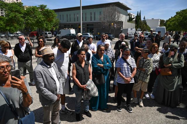 Mourners take part in a minute of silence during a commemorative march in tribute to the victims of a shooting in the Moulins neighbourhood of Nice, south-eastern France on May 23, 2026. Two men and a woman suspected of being involved in the shooting that left two people dead and six injured in Nice on May 11, 2026  have been charged and remanded in custody, in a new case illustrating the “turf wars” associated with drug-related gang activity. (Photo by Miguel MEDINA / AFP)