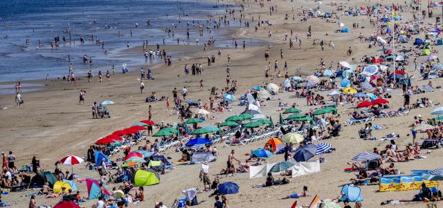 Sunbathers enjoy the beach during a warm spring day in Scheveningen on May 23, 2026. The temperature is expected to rise well above 25 degrees in the coming days. (Photo by Robin Utrecht / ANP / AFP) / Netherlands OUT