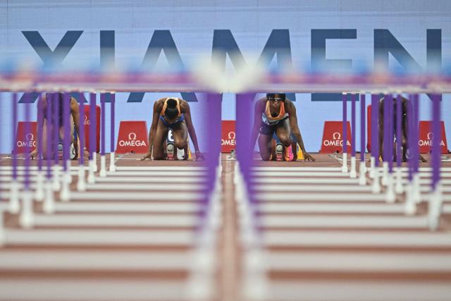 US' Masai Russell (C-L) and Bahamas's Devynne Charlton (C-R) prepare to compete in the women's 100m hurdles final event during the Xiamen Diamond League athletics meeting at Egret Stadium in Xiamen, in China’s eastern Fujian province on May 23, 2026. (Photo by Hector RETAMAL / AFP)