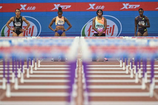 US' Masai Russell (C-L) and Bahamas's Devynne Charlton (C-R) prepare to compete in the women's 100m hurdles final event during the Xiamen Diamond League athletics meeting at Egret Stadium in Xiamen, in China’s eastern Fujian province on May 23, 2026. (Photo by Hector RETAMAL / AFP)