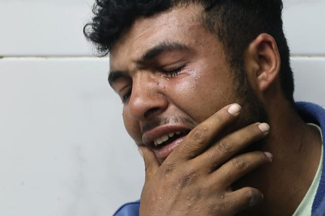 A Palestinian mourner reacts as the bodies of several people brought to the al-Shifa Hospital are taken for burial, in Gaza City on May 23, 2026, after Israeli airstrike targeted a police post in the Al-Tuam area, west of Jabalia in the northern Gaza Strip. An Israeli strike killed five police officers in the northern Gaza Strip on May 23, said a hospital and the Palestinian territory's police force, which operates under Hamas authority. A ceasefire has been in place since October 2025, but Israel reserves the right to strike targets it deems a threat. (Photo by Omar AL-QATTAA / AFP)