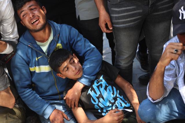 Palestinian mourners react as the bodies of several people brought to the al-Shifa Hospital are taken for burial, in Gaza City on May 23, 2026, after Israeli airstrike targeted a police post in the Al-Tuam area, west of Jabalia in the northern Gaza Strip. An Israeli strike killed five police officers in the northern Gaza Strip on May 23, said a hospital and the Palestinian territory's police force, which operates under Hamas authority. A ceasefire has been in place since October 2025, but Israel reserves the right to strike targets it deems a threat. (Photo by Omar AL-QATTAA / AFP)