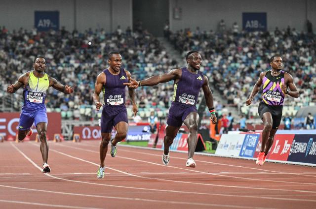 Kenya's Ferdinand Omanyala (2nd R) reacts after crossing the finish line to win in the men's 100m event during the Diamond League Xiamen athletics meeting in Xiamen, in China’s southeast Fujian province on May 23, 2026. (Photo by Hector RETAMAL / AFP)