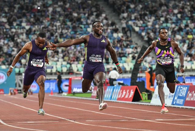 Kenya's Ferdinand Omanyala (C) reacts after crossing the finish line to win in the men's 100m event during the Diamond League Xiamen athletics meeting in Xiamen, in China’s southeast Fujian province on May 23, 2026. (Photo by Hector RETAMAL / AFP)