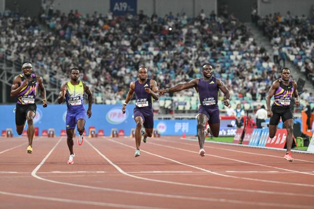 Kenya's Ferdinand Omanyala (2nd R) competes in the men's 100m event during the Diamond League Xiamen athletics meeting in Xiamen, in China’s southeast Fujian province on May 23, 2026. (Photo by Hector RETAMAL / AFP)