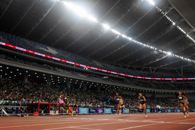 Jamaica's Shericka Jackson (L) crosses the finish line to win the women's 200m final event during the Xiamen Diamond League athletics meeting at Egret Stadium in Xiamen, in China’s eastern Fujian province on May 23, 2026. (Photo by Hector RETAMAL / AFP)