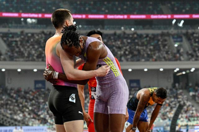 Winner Brazil's Alison Dos Santos (R) celebrates with second-placed Norway's Karsten Warholm at the end of the men's 400m hurdles final event during the Xiamen Diamond League athletics meeting at Egret Stadium in Xiamen, in China’s eastern Fujian province on May 23, 2026. (Photo by Hector RETAMAL / AFP)