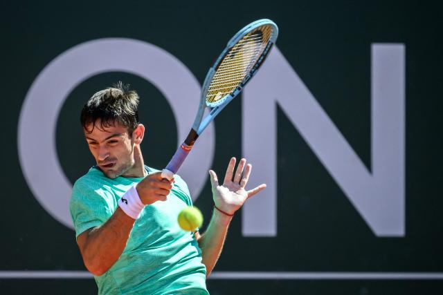 Argentina's Mariano Navone plays a forehand return to US's Learner Tien during their men's singles final match at the ATP 250 Geneva Open tennis tournament in Geneva on May 23, 2026. (Photo by Fabrice COFFRINI / AFP)