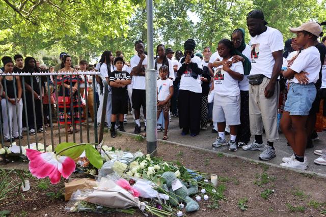 Felix Mankoka (2R), Olga Mankoka (3R) and relatives stand in front of flowers and messages during a silent march in tribute to their son Elidjah Mankoka in Nantes, western France on May 23, 2026, after his death by shooting on May 14. The death of fifteen year-old Elidjah along with the wounding of two other minors on the same day, took place in the Port-Boyer neighbourhood on the western French city, which had already been hit by deadly shootings linked to drug trafficking earlier in the year. (Photo by Fred TANNEAU / AFP)