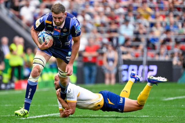 Bordeaux-Begles' French flanker #06 Pierre Bochaton (L) evades a tackle from Leinster's New Zealander scrum-half #09 Jamison Gibson-Park during the European Rugby Champions Cup final match between Union Bordeaux Belges (UBB) and Leinster Rugby at San Mames Stadium in Bilbao on May 23, 2026. (Photo by Ander Gillenea / AFP)