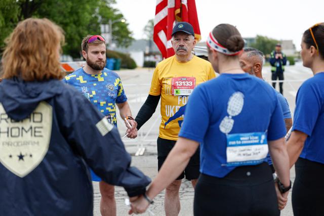 Former Deputy Minister ofDefense of Ukraine, retired Major General  Volodymyr Havrylov (C) and veteran Yurii Tsyntylevych (2-L) participate in the annual Soldier Field 10 race and other commemorative activities to honor fallen American and Ukrainian service members during a Memorial Day tribute in Chicago, on May 23, 2026. Active-duty Ukrainian soldiers participate in the annual Soldier Field 10 race and other commemorative activities to honor fallen American and Ukrainian service members during a Memorial Day tribute in Chicago, on May 23, 2026. (Photo by KAMIL KRZACZYNSKI / AFP)