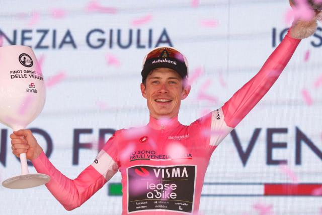 Team Visma Lease a Bike Danish rider Jonas Vingegaard celebrates the overall leader's pink jersey on the podium after winning the 14th stage of the Giro d'Italia 2026 - Tour of Italy cycling race between Aosta and Pila (Gressan), Italy, on May 23, 2026. (Photo by Luca Bettini / AFP)