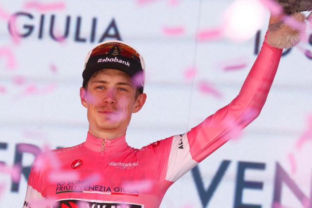 Team Visma Lease a Bike Danish rider Jonas Vingegaard celebrates the overall leader's pink jersey on the podium after winning the 14th stage of the Giro d'Italia 2026 - Tour of Italy cycling race between Aosta and Pila (Gressan), Italy, on May 23, 2026. (Photo by Luca Bettini / AFP)