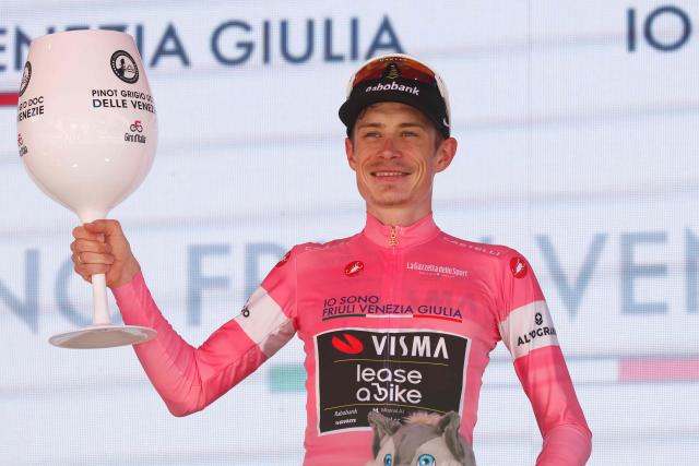 Team Visma Lease a Bike Danish rider Jonas Vingegaard celebrates the overall leader's pink jersey on the podium after winning the 14th stage of the Giro d'Italia 2026 - Tour of Italy cycling race between Aosta and Pila (Gressan), Italy, on May 23, 2026. (Photo by Luca Bettini / AFP)