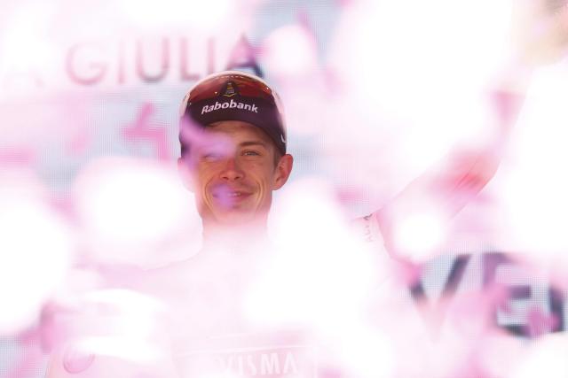 Team Visma Lease a Bike Danish rider Jonas Vingegaard celebrates the overall leader's pink jersey on the podium after winning the 14th stage of the Giro d'Italia 2026 - Tour of Italy cycling race between Aosta and Pila (Gressan), Italy, on May 23, 2026. (Photo by Luca Bettini / AFP)