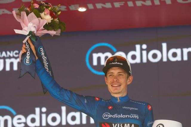 Team Visma Lease a Bike Danish rider Jonas Vingegaard poses with the best climber's blue jersey on the podium after winning the 14th stage of the Giro d'Italia 2026 - Tour of Italy cycling race between Aosta and Pila (Gressan), Italy, on May 23, 2026. (Photo by Luca Bettini / AFP)