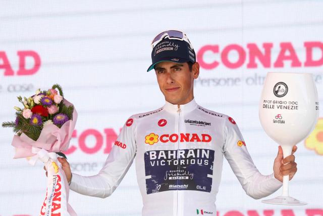 Bahrain - Victorious Portuguese rider Afonso Eulalio poses with the best young rider's white jersey on the podium after winning the 14th stage of the Giro d'Italia 2026 - Tour of Italy cycling race between Aosta and Pila (Gressan), Italy, on May 23, 2026. (Photo by Luca Bettini / AFP)