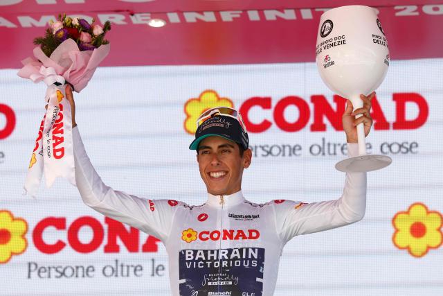 Bahrain - Victorious Portuguese rider Afonso Eulalio poses with the best young rider's white jersey on the podium after winning the 14th stage of the Giro d'Italia 2026 - Tour of Italy cycling race between Aosta and Pila (Gressan), Italy, on May 23, 2026. (Photo by Luca Bettini / AFP)