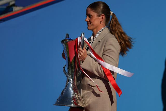 Norwegian footballer Maren Mjelde carries the  Women's Champions League Trophy onto the pitch ahead of the UEFA Women's Champions League final football match between FC Barcelona and Olympique Lyonnais (OL) at the Ullevaal Stadium in Oslo, Norway on May 23, 2026. (Photo by Odd ANDERSEN / AFP)