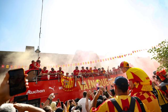 RC Lens' players parade for supporters atop a double-decker bus during celebrations following their victory in the French Cup final football match against OGC Nice, in Lens, northern France on May 23, 2026. (Photo by FRANCK FIFE / AFP)