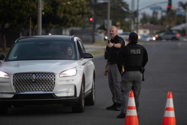 (FILES) Garden Grove police direct evacuees towards a shelter after a chemical leak from a large storage tank threatened residents in Garden Grove, California on May 22, 2026. Tens of thousands of people were ordered to leave their homes in California on May 22, after a huge chemical tank began leaking, with warnings it might blow up, sending toxic fumes over a heavily populated area. (Photo by Blake Fagan / AFP)