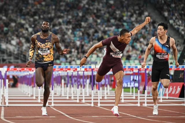 US's Jamal Britt (C) crosses the finish line to win the men's 110m hurdles final event during the Xiamen Diamond League athletics meeting at Egret Stadium in Xiamen, in China’s eastern Fujian province on May 23, 2026. (Photo by Hector RETAMAL / AFP)