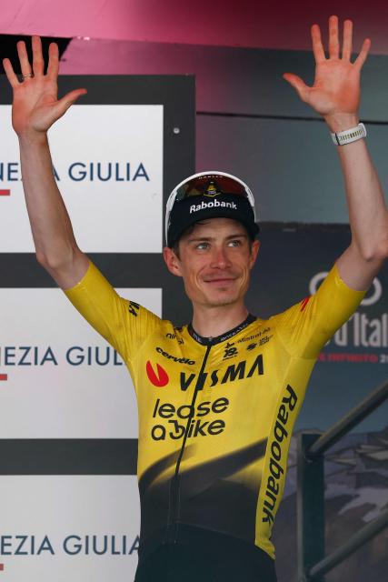 Team Visma Lease a Bike Danish rider Jonas Vingegaard celebrates on the podium after winning the 14th stage of the Giro d'Italia 2026 - Tour of Italy cycling race between Aosta and Pila (Gressan), Italy, on May 23, 2026. (Photo by Luca Bettini / AFP)
