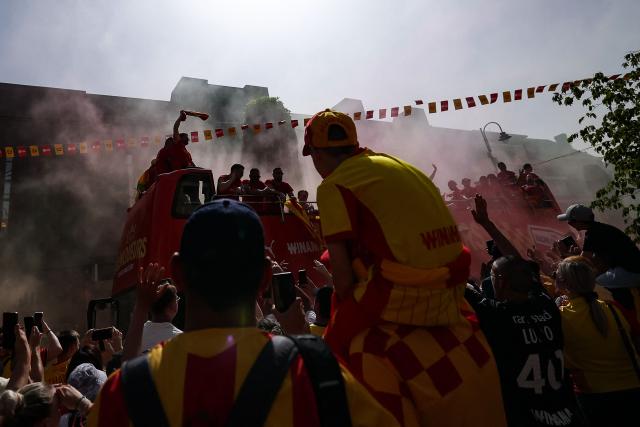 RC Lens' players parade for supporters atop a double-decker bus during celebrations following their victory in the French Cup final football match against OGC Nice, in Lens, northern France on May 23, 2026. (Photo by FRANCK FIFE / AFP)
