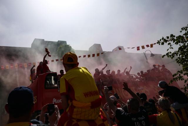 RC Lens' players parade for supporters atop a double-decker bus during celebrations following their victory in the French Cup final football match against OGC Nice, in Lens, northern France on May 23, 2026. (Photo by FRANCK FIFE / AFP)