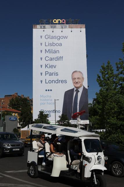 A picture taken on May 23, 2026 shows a giant billboard of Florentino Perez, Real Madrid's current president and candidate for the next Real Madrid's president election. Perez, 79, was first elected as Madrid president in 2000. (Photo by Pierre-Philippe MARCOU / AFP)