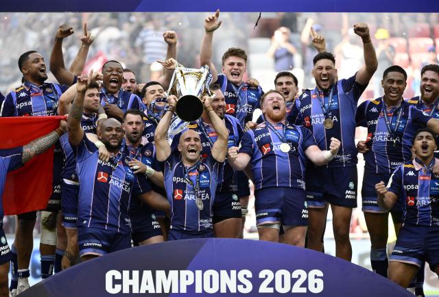 Bordeaux-Begles' players celebrate with the cup after winning the European Rugby Champions Cup final match between Union Bordeaux Belges (UBB) and Leinster Rugby at San Mames Stadium in Bilbao on May 23, 2026. (Photo by Ander Gillenea / AFP)