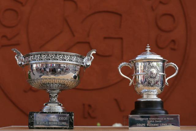 This photograph shows the French Open Mens singles trophy, the Musketeers’ cup (L) and the French Open Women's singles trophy, the Suzanne-Lenglen cup (R), on display at the Roland-Garros Complex in Paris on May 23, 2026. (Photo by Thomas SAMSON / AFP)