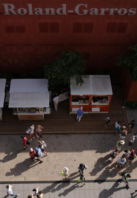 Visitors walk at the Roland-Garros Complex during the French Open tennis tournament in Paris on May 23, 2026. (Photo by Thomas SAMSON / AFP)