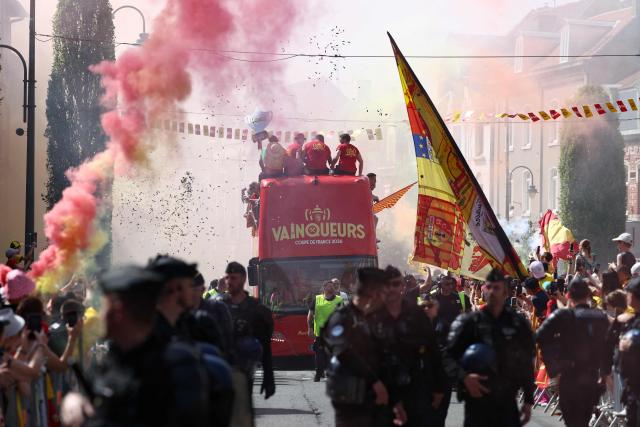 RC Lens' players parade for supporters atop a double-decker bus during celebrations following their victory in the French Cup final football match against OGC Nice, in Lens, northern France on May 23, 2026. (Photo by FRANCK FIFE / AFP)