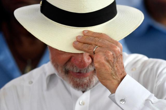 Brazil's President Luiz Inacio Lula da Silva adjusts his hat during the inauguration of the Center for Technological Development in Health (CDTS/Fiocruz) and the launch of the Center for Development and Production of CAR-T Therapies, which will allow national production of cell therapies at reduced prices, at Fiocruz in Rio de Janeiro, Brazil, on May 23, 2026. (Photo by Daniel RAMALHO / AFP)