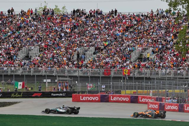 Spectators watch as (L/R) Mercedes' British driver George Russell races ahead of McLaren's British driver Lando Norris during the Sprint race ahead of the 2026 Formula 1 Grand Prix du Canada at Circuit Gilles-Villeneuve in Montreal, Canada, on May 23, 2026. (Photo by Cristobal Herrera Ulashkevich / POOL / AFP)