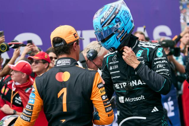 Mercedes' British driver George Russell (R) is congratulated by second place McLaren's British driver Lando Norris after winning the Sprint race ahead of the 2026 Formula 1 Grand Prix du Canada at Circuit Gilles-Villeneuve in Montreal, Canada, on May 23, 2026. (Photo by Geoff Robins / AFP)