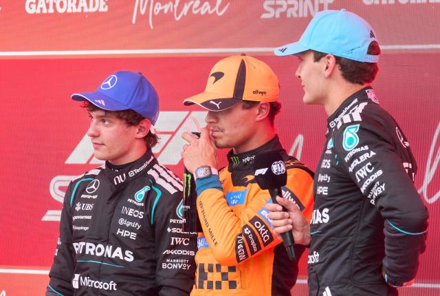 First place Mercedes' British driver George Russell (R), second place McLaren's British driver Lando Norris (C) and third place Mercedes' Italian driver Kimi Antonelli are interviewed after the Sprint race ahead of the 2026 Formula 1 Grand Prix du Canada at Circuit Gilles-Villeneuve in Montreal, Canada, on May 23, 2026. (Photo by Geoff Robins / AFP)