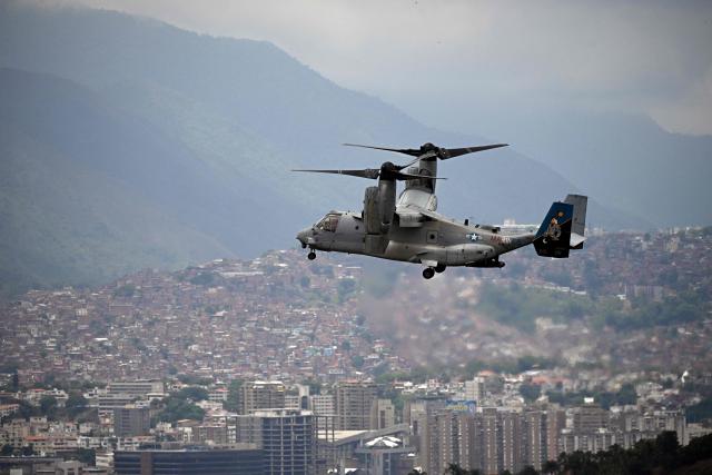 A US Marines MV-22B Osprey aircraft flies over the city on its way to the US Embassy, in Caracas, on May 23, 2026, during an air evacuation drill. (Photo by Federico PARRA / AFP)