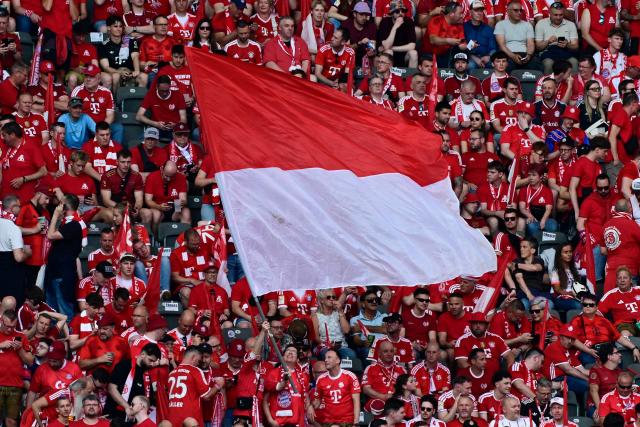 Fans of Bayern Munich cheer with a giant flag ahead the German Cup (DFB Pokal) final football match FC Bayern Munich v VfB Stuttgart at the Olympic Stadium in Berlin, on May 23, 2026. (Photo by John MACDOUGALL / AFP) / DFB REGULATIONS PROHIBIT ANY USE OF PHOTOGRAPHS AS IMAGE SEQUENCES AND QUASI-VIDEO.